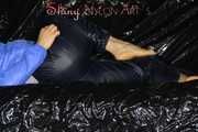 Sexy Sandra wearing a supersexy black shiny nylon rain pants and a sexy shiny blue rain jacket lolling on the sofa (Pics)