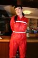 Jill bound in a red nylon rainsuit