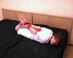 Barefoot nurse Gatitta tied up with a red rope (video)
