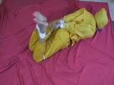 two short videos with our archive girls tid and gagged in shiny nylon rainwear