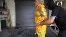 Ms Ungeniert tied and gagged in shiny nylon Rainwear trying to escape