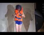Mara wearing a sexy shiny swimsuit and a shiny nylon shorts trying on a lifevest (Video)