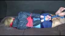 Pia tied and gagged with gymnastic bands and a cloth gag on bed wearing a sexy shiny nylon shorts and an oldschool rain jacket (Video)
