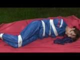 a video with Nicole tied and gagged in a shiny blue PVC suit