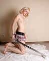 Topless barefoot Hannah, handcuffed and legcuffed with steel restraints, poses for the camera