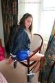 Stella tied and gagged on a chair wearing a blue shiny nylon shorts and a rain jacket (Pics)