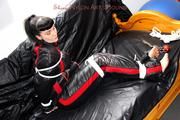 Jill bound and gagged in a shiny nylon skisuit