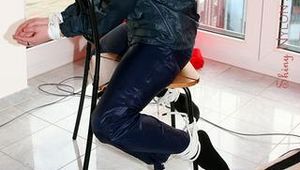 Marlin tied and gagged in a shiny blue rainsuit
