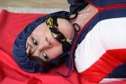 Julia tied and gagged in a shiny nylon skisuit