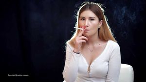 Very serious girl Valya looking straight into the camera and smoking a 120mm