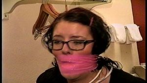 25 YEAR OLD DAY CARE WORKER IS MOUTH STUFFED, HANDGAGGED, WRAP BONDAGE TAPE GAGGED, TOE-TIED WEARING NYLON STOCKINGS WHILE TIED TO A CHAIR AND WEARING EYE GLASSES (D72-6)