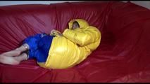 Sonja wearing a blue rain pants and a yellow PAMY down jacket while bonding herself an the sofa (Video)