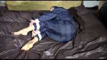 Sexy Sandra wearing a sexy blue shiny nylon pants and a sexy blue rain jacket tied and gagged with ropes and a cloth gag on a bed (Video)