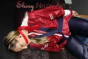 Sexy Sandra wearing sexy red/blue rainwear being tied and gagged with ropes and a clothgag on a chair (Pics)