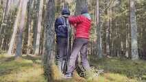 Sebastien breathplay tied up in a puffer jacket among the trees.