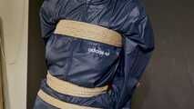 Lana tied and gagged and gagged to Post in shiny nylon Rainwear