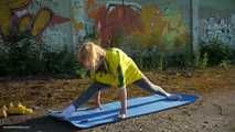 Anastasia is doing some fitness and stretching while smoking outdoors