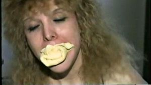 28 YR OLD BEAUTIFUL DOE EYED REBECCA IS MOUTH STUFFED, CLEAR WHITE TAPE GAGGED, RUBBER BAND BALL-GAGGED, HANDCUFFED & BOUND WITH TAPE (D46-9)