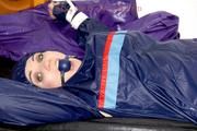 Jill tied and gagged in shiny nylon rainware