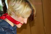Sonja tied and gagged standing on a chair wearing a sexy red shiny nylon shorts and a darkblue rain jacket (Pics)