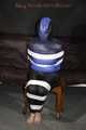 Sexy Mara wearing a black rain pants and a blue/black down jacket being tied, gagged and hooded with tape and clothgag (Pics)