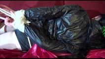 Lucy tied and gagged on a sofa wearing a sexy black shiny nylon shorts and a rain jacket (Video)