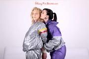 Sophie tied and gagged by Jill on a sofa wearing a shiny silver PVC sauna suit which is slitted by Jill (Pics)