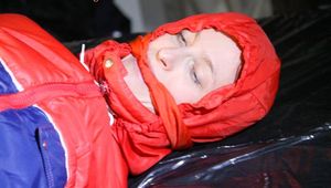 Sonja tied and gagged on a bed wearing an sexy oldschool shiny nylon downwear combination (Pics)