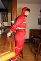 Jill bound in a red nylon rainsuit