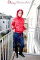 Marlin posing on a balcony wearing sexy black shiny nylon rainpants and a red down jacket (Pics)