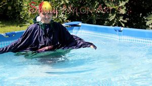 Mara sunbathing and swimming in the pool wearing sexy shiny nylon rainwear and a raincape (Pics)