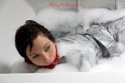 Simone in an shiny grey pvc sauna suit tied and gagged by Sophie in the bath tub (pics)