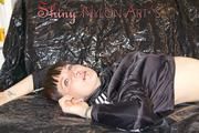 Mara wearing a supersexy black shiny nylon shorts and a super short belly rain jacket lolling on a white sofa (Pics)