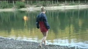 Jenny bathing in a lake and sun bathing wearing sexy red shiny nylon shorts and a rain jacket (Video)
