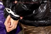 Samantha tied and gagged on bed wearing shiny downpants in brown and a black downjacket (Pics)