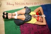 Stella tied and gagged on the floor wearing a shiny nylon rain pants (Pics)