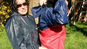 Jill and her friend in the garden playing with eachother wearing sexy shiny nylon rainwear (Pics)