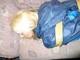 Archive girl tied and gagged with tape and rope wearing shiny nylon rainwear in blue (Pics)