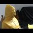 Jill tied and gagged on a chair wearing a yellow rainsuit and coveres with an yellow raincoat with two hoods (Video)