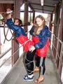 two of our archive girls in shiny nylon rainwear and bondage