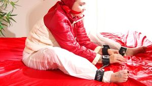 Jill ties, gagges and hoodes herself with a bar sitting on a bed wearing a sexy white rain pants and an oldschool down jacket (Pics)