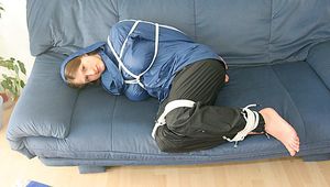 Katharina tied, gagged and hooded (breath control) on a sofa wearing sexy shiny nylon rainwear (Pics)