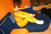 Archive girl tied and gagged on sofa wearing a shiny yellow rainwear (Pics)