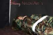 Sexy PIA being tied and gagged with tape and a clothgag on the sofa wearing a camouflage rainsuit and yellow rubber boots (Pics)