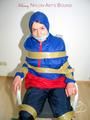 Katharina tied by using tape, gagged and hooded on a chair wearing sexy red/blue rainwear (Pics)