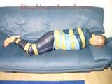 Leoni tied, gagged and hooded with tape wearing a sexy blue rainwear combination (Pics)