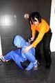 Jill bound and gagged by Simone in shiny nylon rainwear