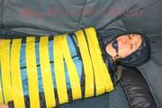 Katharina tied and gagged with tape on a sofa wearing shiny rainwear (Pics)