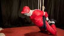 Sebastien breathplay in a red PVC jumpsuit.