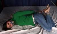 Roxana hogtied on bed